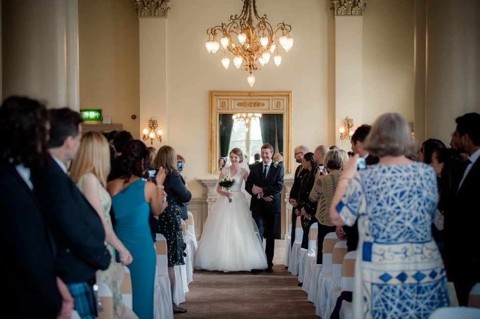 bride walks down aisle at a wedding at the Balmoral, Edinburgh